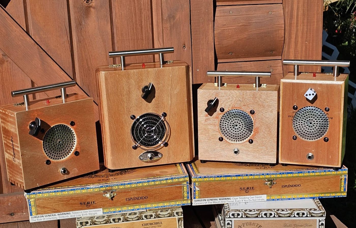 Four cigar box amps with steel handles