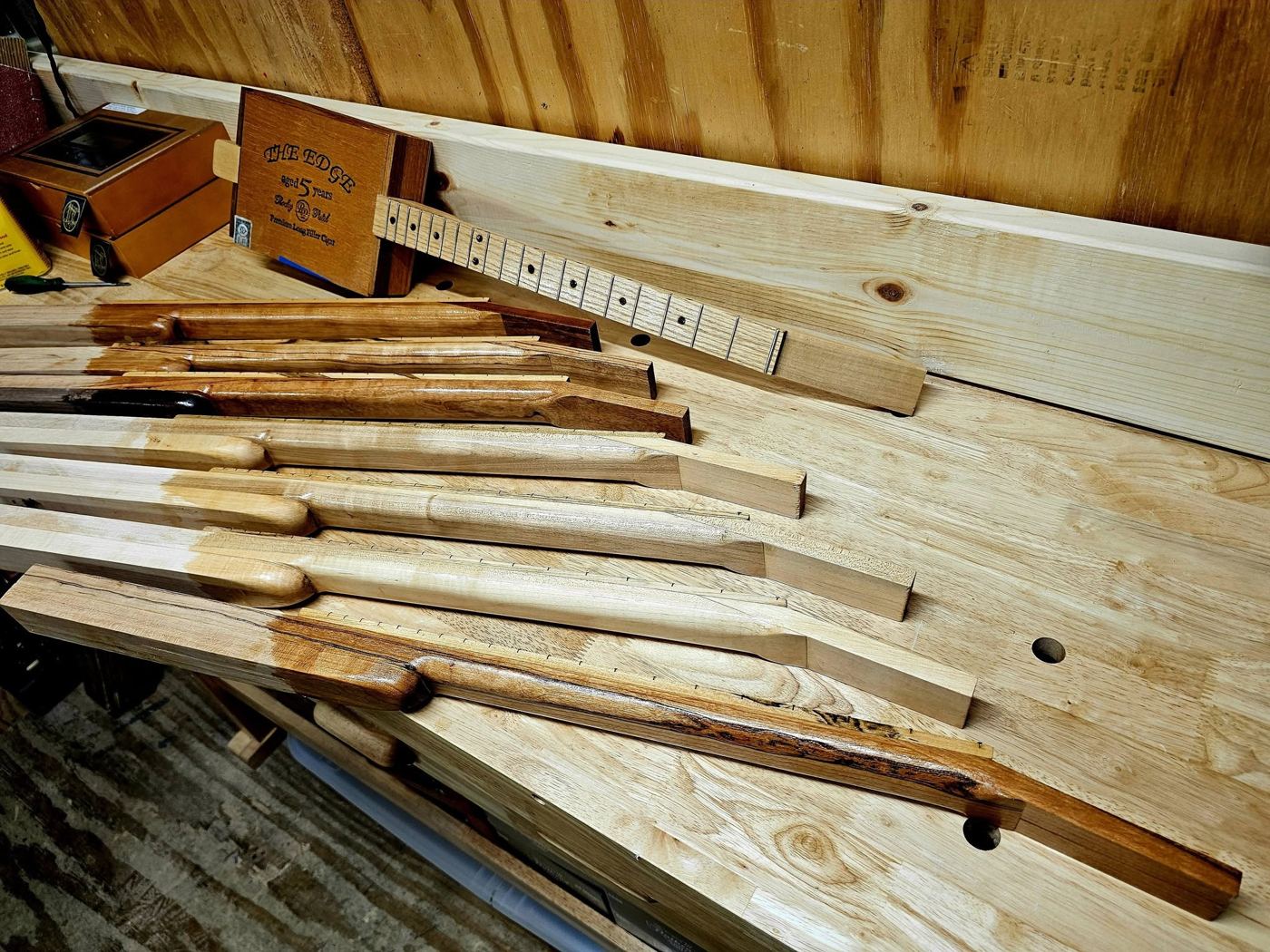 Wormy maple necks being glued on the bench
